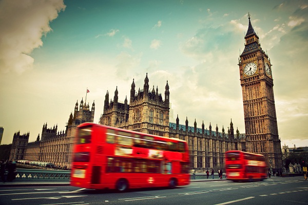 London, the UK. Red bus in motion and Big Ben