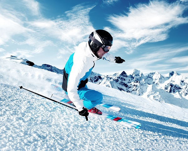 Skier in mountains, prepared piste