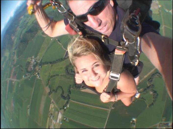 Woman sky diving with instructor