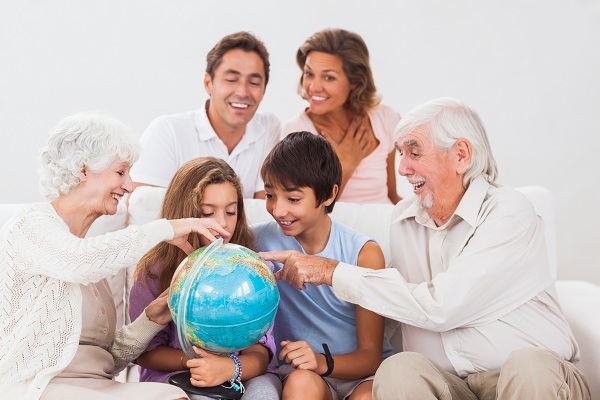 Extended family looking at globe on couch