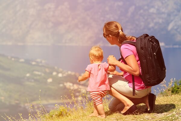 mother with little daughter travel in mountains