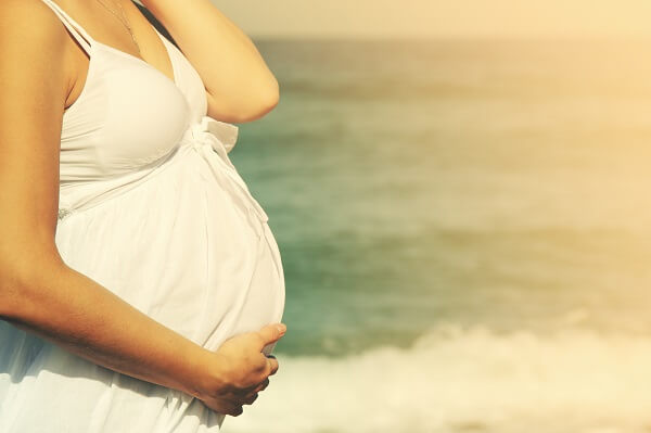 Pregnant woman on beach