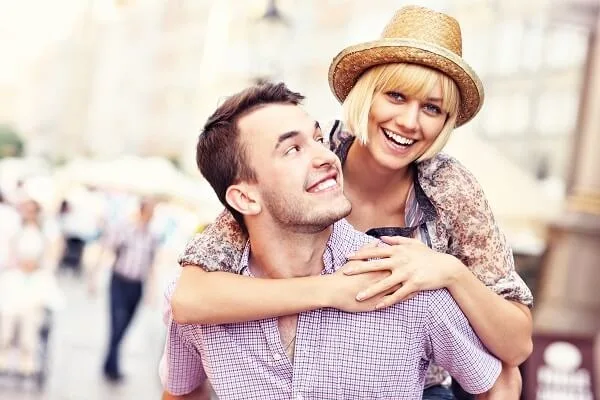 Happy couple on holiday piggyback