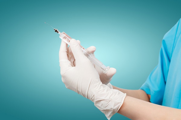 Doctor's hands holding syringe