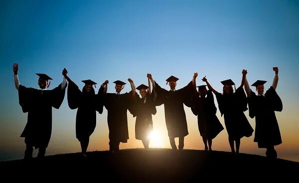 Group of friends cheering at graduation