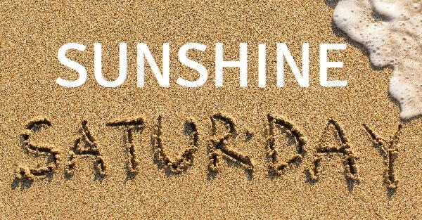 Sunshine Saturday written in the sand