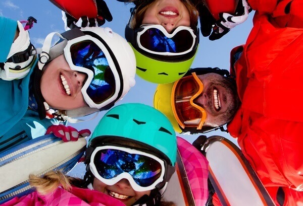 Family on ski holiday with ski helmets